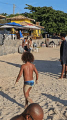 Children play with coconut on Búzios beach