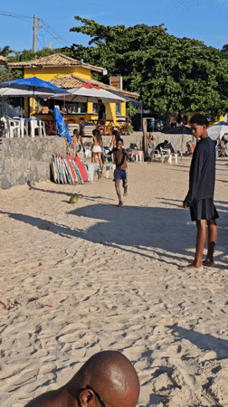 Children play with coconut on Búzios beach