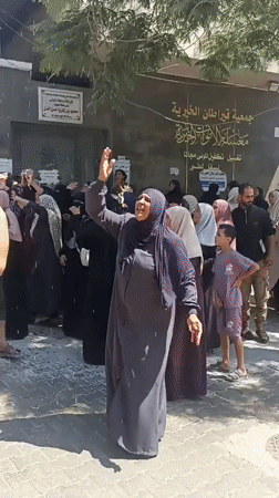 Crowd gathers outside Gaza public building amid visible tension