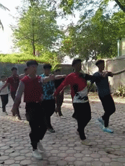 Young men perform synchronized outdoor exercises in Lhokseumawe