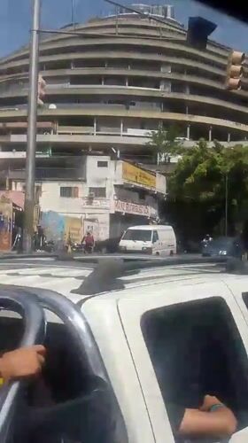 Street-level views near a circular landmark in Caracas