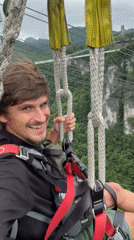 Tourist zip-lines through Zhangjiajie scenic area in early morning