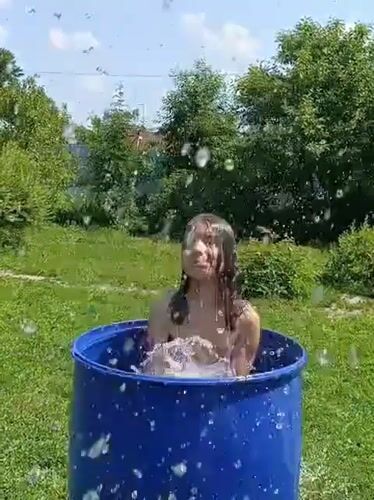 Summer backyard cooling off session captured in Lagovskoe