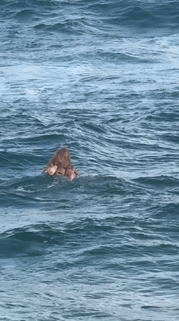 Blonde surfer enjoys session at Midigama Beach, Sri Lanka