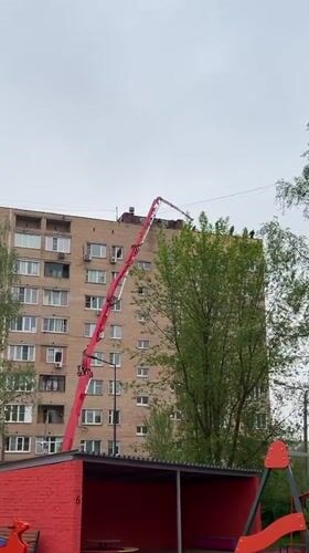 Construction work underway on building roof in Mytishchi