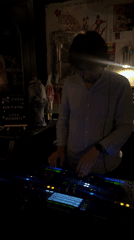 DJ working the decks at a Paris bar, Saturday night