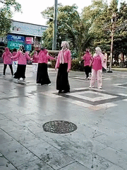 Synchronized outdoor aerobics session at a public square in Pati