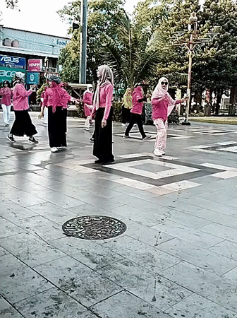 Synchronized outdoor aerobics session at a public square in Pati