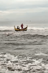 Fishing boats navigate choppy waters off Indonesian coast