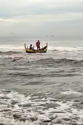 Fishing boats navigate choppy waters off Indonesian coast