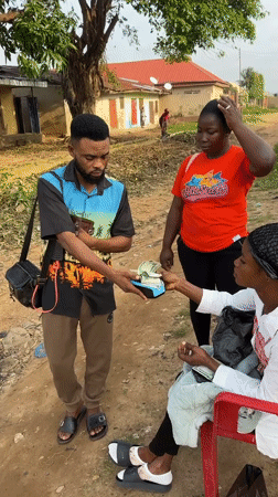 Cash and card transaction on a Narayi dirt road