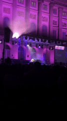 Outdoor piano concert illuminates historic Milan building in purple lights