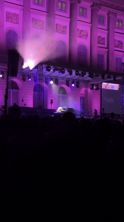 Outdoor piano concert illuminates historic Milan building in purple lights