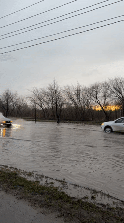 Cars navigate flooded street in Ulyanovsk, Russia