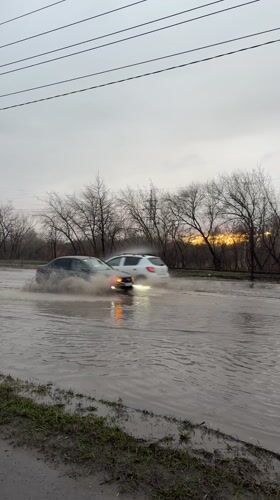 Cars navigate flooded street in Ulyanovsk, Russia