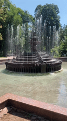 Stone fountain and inscribed building at an unknown location
