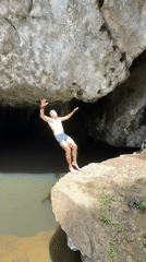 Cliff jumping into a cave pool in Ao Luek, Thailand