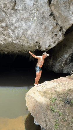 Cliff jumping into a cave pool in Ao Luek, Thailand