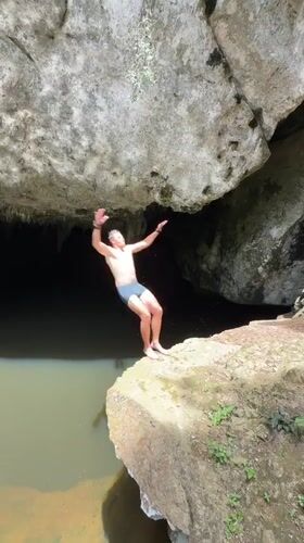 Cliff jumping into a cave pool in Ao Luek, Thailand