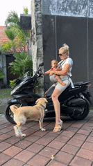 Woman, baby, dog share motorcycle ride in North Kuta