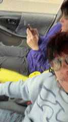Young adults filmed making playful gestures in car, Sofia
