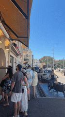 Busy street scene captured in Saint-Tropez on sunny day
