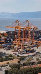 Orange cranes work a busy container ship at Rijeka port