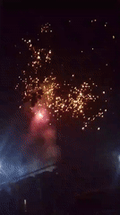 Fireworks display draws crowds, woman walks through scattered money