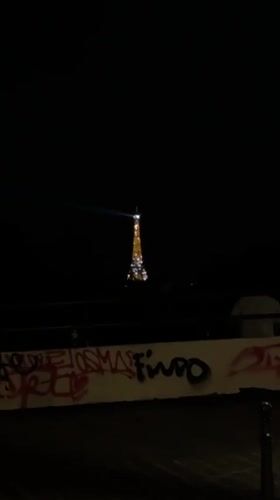 Eiffel Tower's nightly illumination observed from Paris street