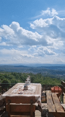 Tourist enjoys lemonade lunch at scenic Arbanassi terrace restaurant
