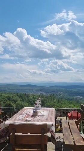 Tourist enjoys lemonade lunch at scenic Arbanassi terrace restaurant