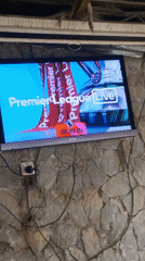 Jos resident watches Arsenal-Manchester City Premier League match on TV