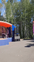 Outdoor festival in full swing along a Russian riverside town