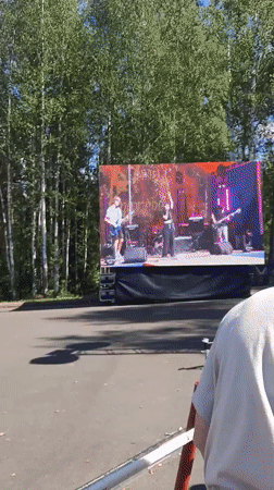 Outdoor festival in full swing along a Russian riverside town