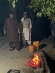 Men gather around cooking fire in Dehkheshk, Afghanistan