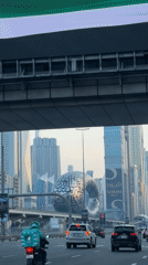 Vehicle drives Dubai highway past iconic landmarks