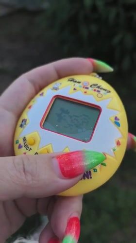 Woman plays with digital pet toy alongside bulldog in Russia