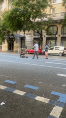 Three men gather in Buenos Aires street, one seated