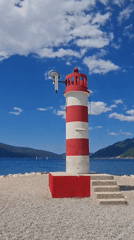 Family beach day captured near iconic lighthouse in Tivat