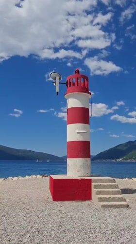 Family beach day captured near iconic lighthouse in Tivat