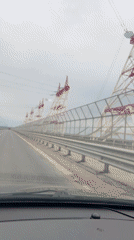 Vehicle crosses bridge in overcast Novocheboksarsk, Russia