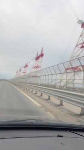 Vehicle crosses bridge in overcast Novocheboksarsk, Russia