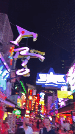 Bangkok nightlife district bustling with neon-lit bars and businesses