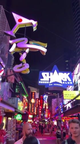Bangkok nightlife district bustling with neon-lit bars and businesses