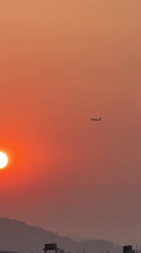 Small plane spotted flying during sunset over Pokhara, Nepal