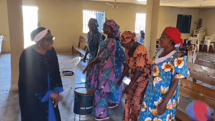 Women perform traditional dance in Bukuru church hall