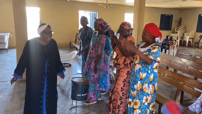 Women perform traditional dance in Bukuru church hall