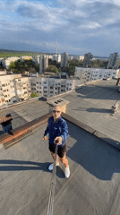 Man films rooftop video content in Pleven, Bulgaria