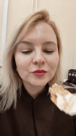 Woman enjoys layered cake breakfast in Izhevsk home