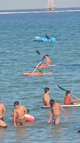 Sanur Beach buzzing with activity on a clear Bali morning